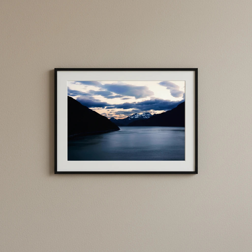 Fine art photography print of a tranquil twilight landscape over an Alaskan fjord near Juneau with snow-capped mountains.
