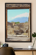 Unframed fine art photograph of ancient stone ruins in Pompeii looking out toward Mount Vesuvius under a soft blue sky.